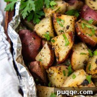 grilled red potatoes in foil with fresh parsley.