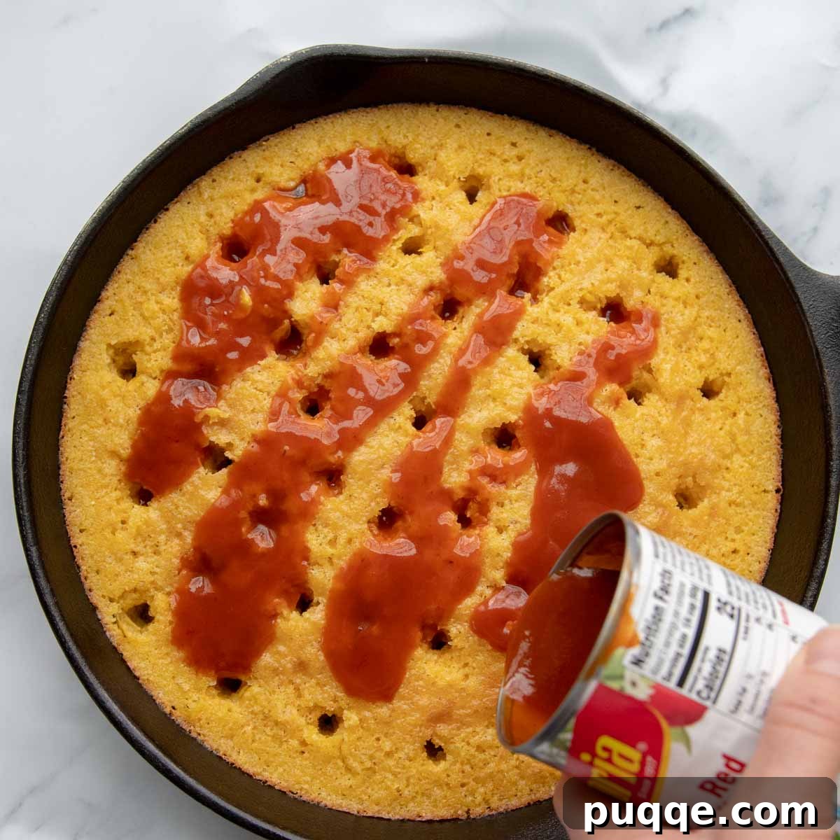 Authentic Gluten-Free Tamale Pie Made From Scratch 5 Enchilada sauce poured over the baked cornbread, seeping into poked holes.
