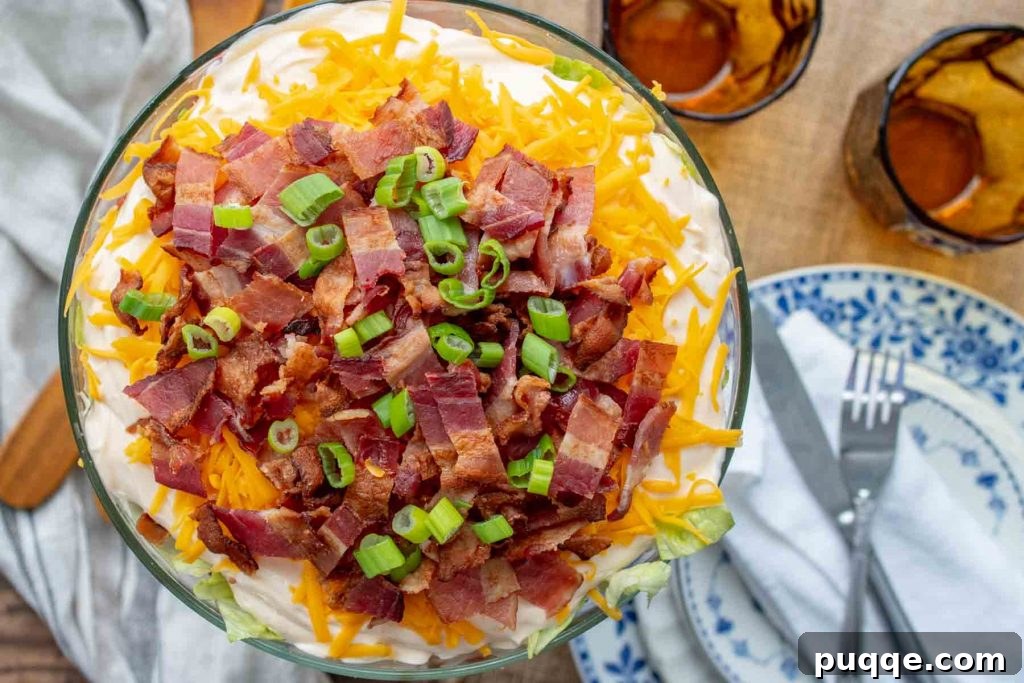 overhead shot of salad with bacon and cheese on top