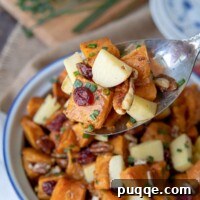Orchard Sweet Potato Salad 7 an antique silver spoon holding up a serving of sweet potato salad recipe from a serving dish