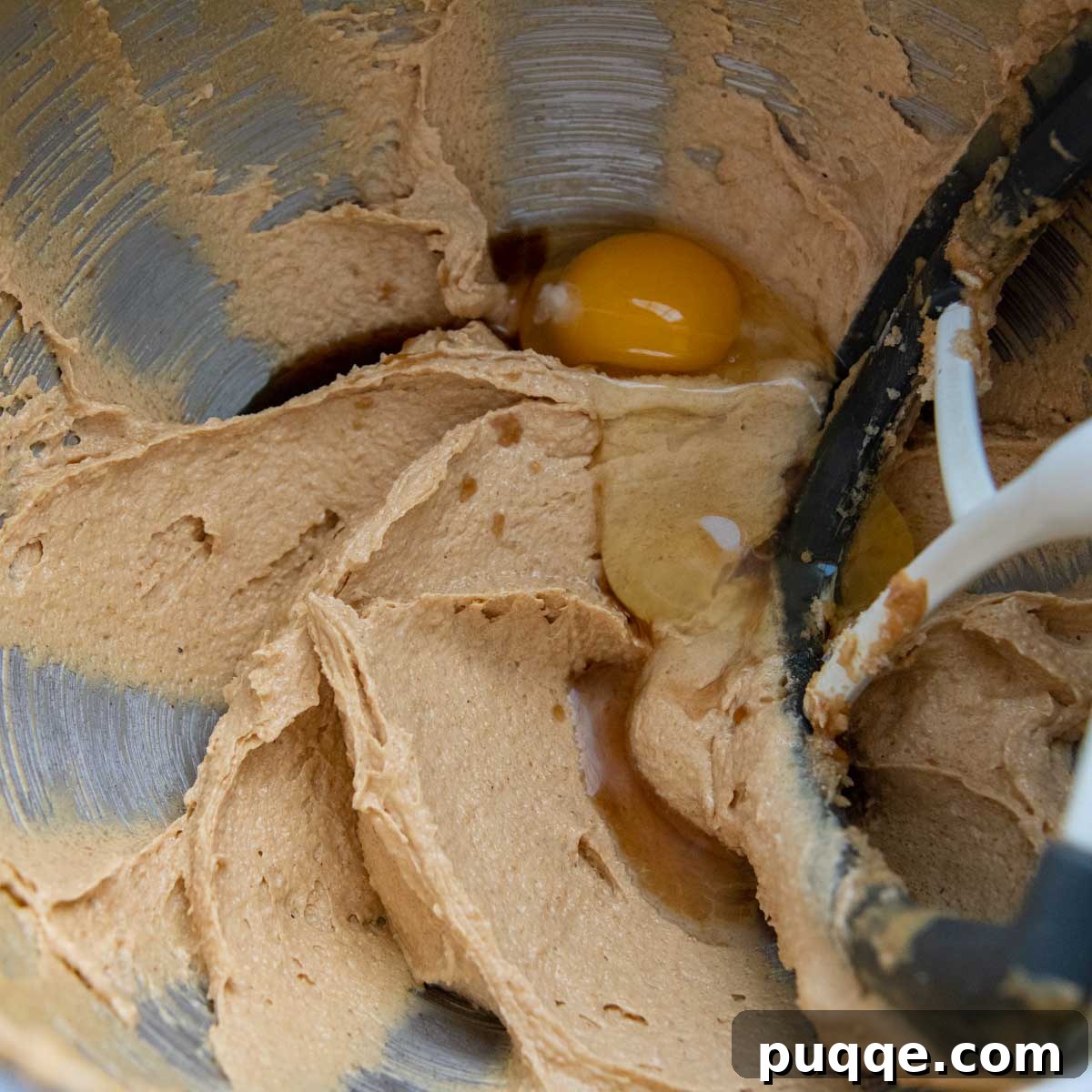Effortless Gluten-Free Peanut Butter Quick Bread 3 Image showing creamy peanut butter bread batter being mixed in a bowl.