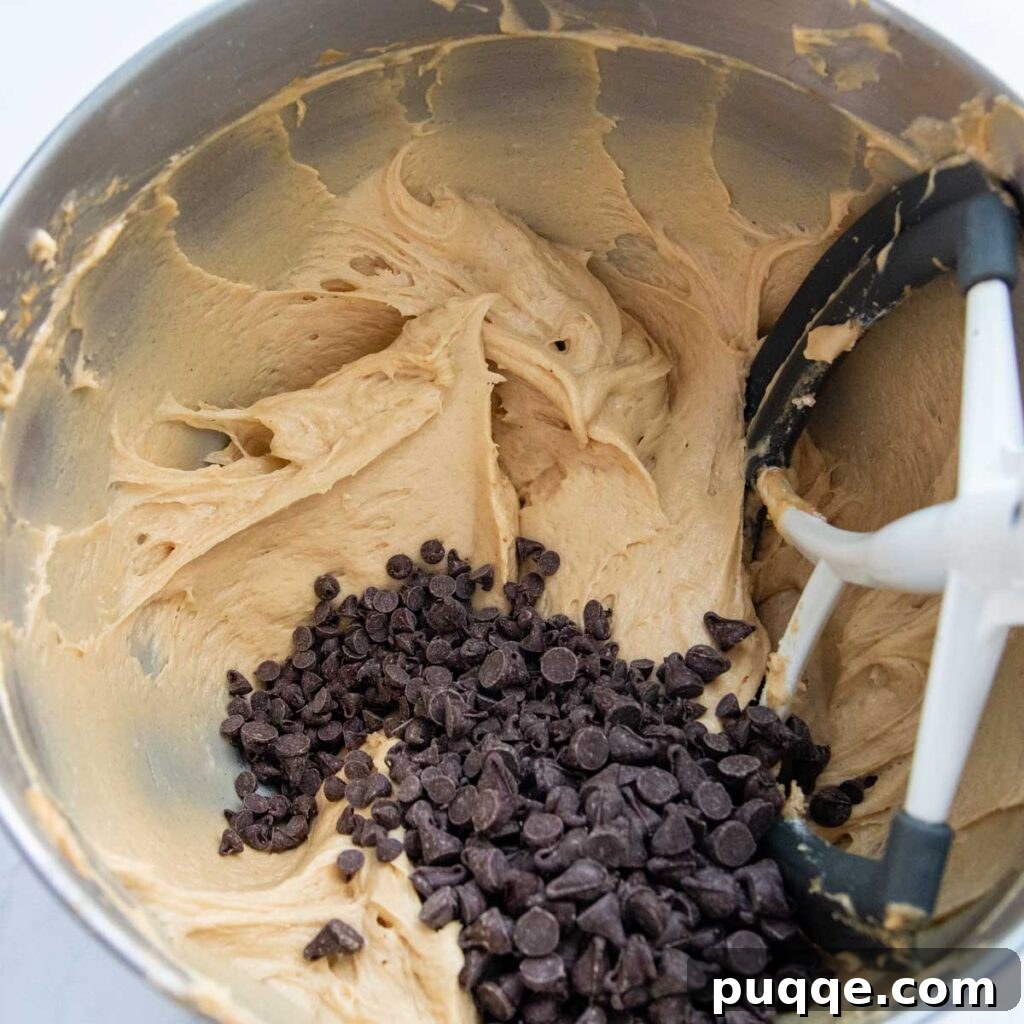 Effortless Gluten-Free Peanut Butter Quick Bread 5 Chocolate chips being stirred into the gluten-free peanut butter bread batter.
