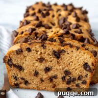 sliced peanut butter chocolate chip bread standing up next to a loaf.