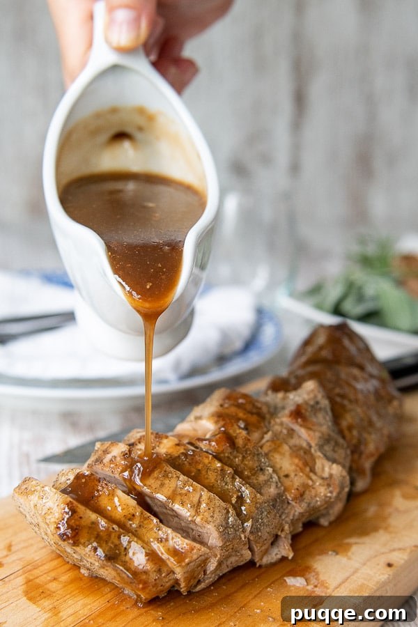 a gravy boat pouring on balsamic sauce on top of cut pieces of instant pot pork