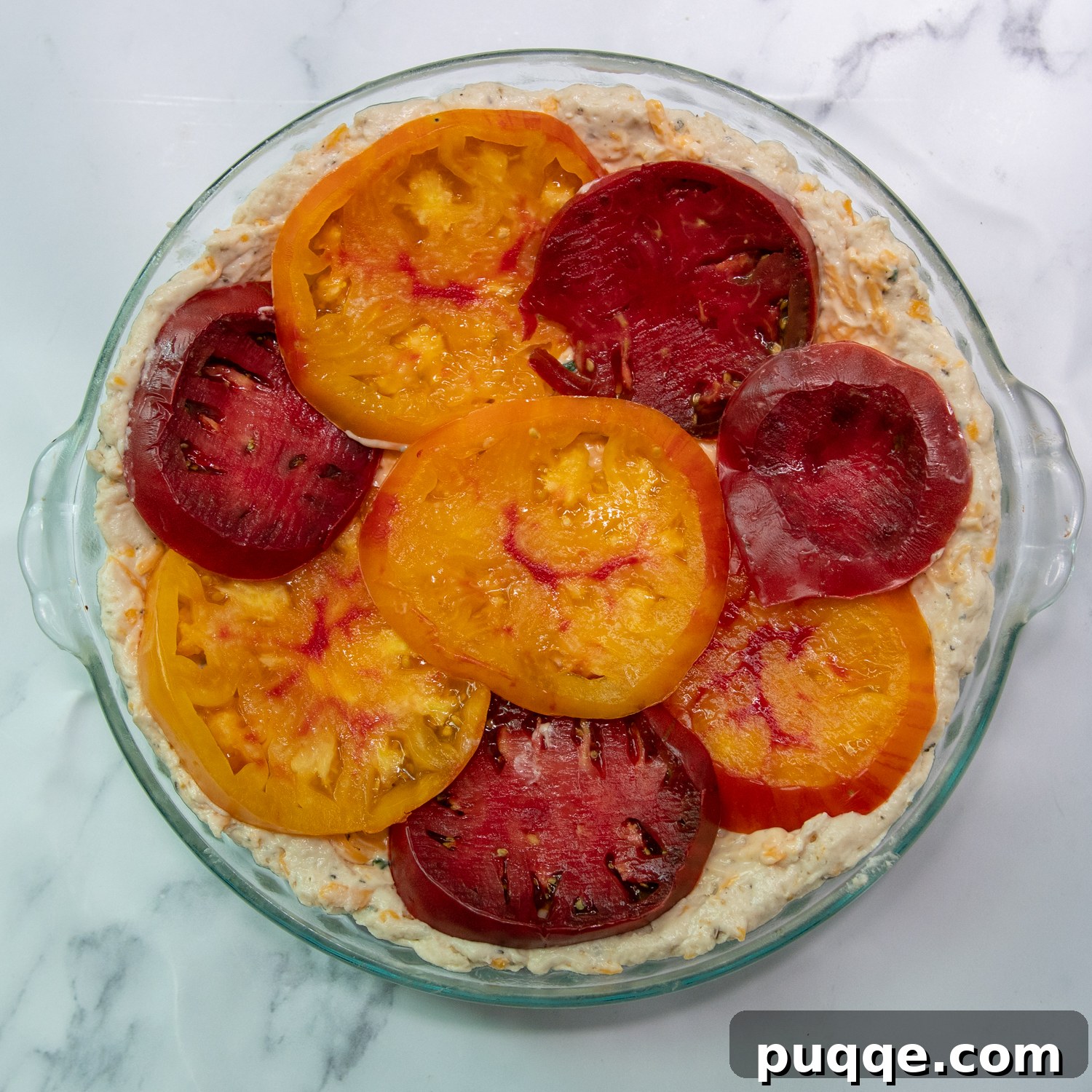 Easy Bisquick Tomato Pie 8 The sliced tomatoes beautifully arranged within the pie crust, topped with half of the cheesy filling.