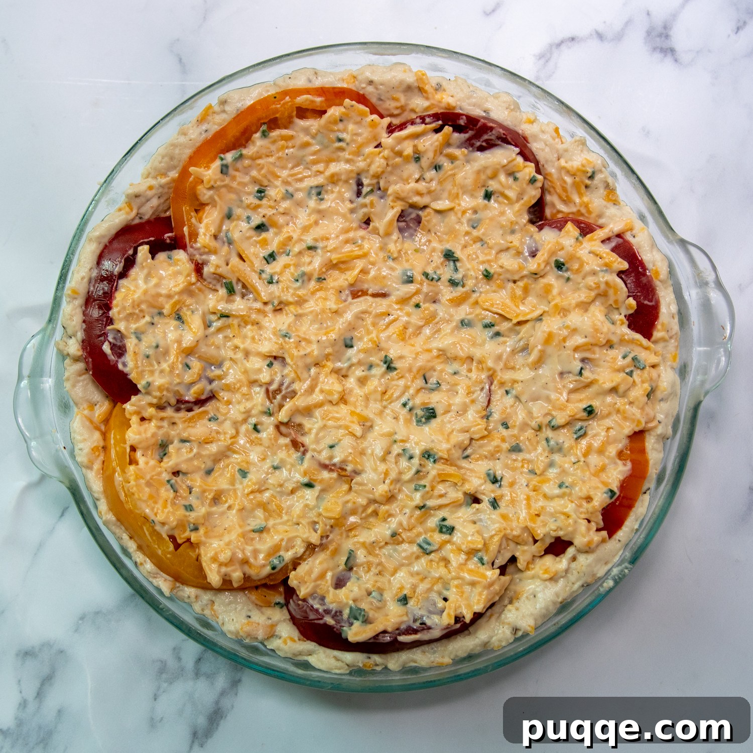 Easy Bisquick Tomato Pie 9 The cheesy filling spread over the tomato slices, ready for baking.