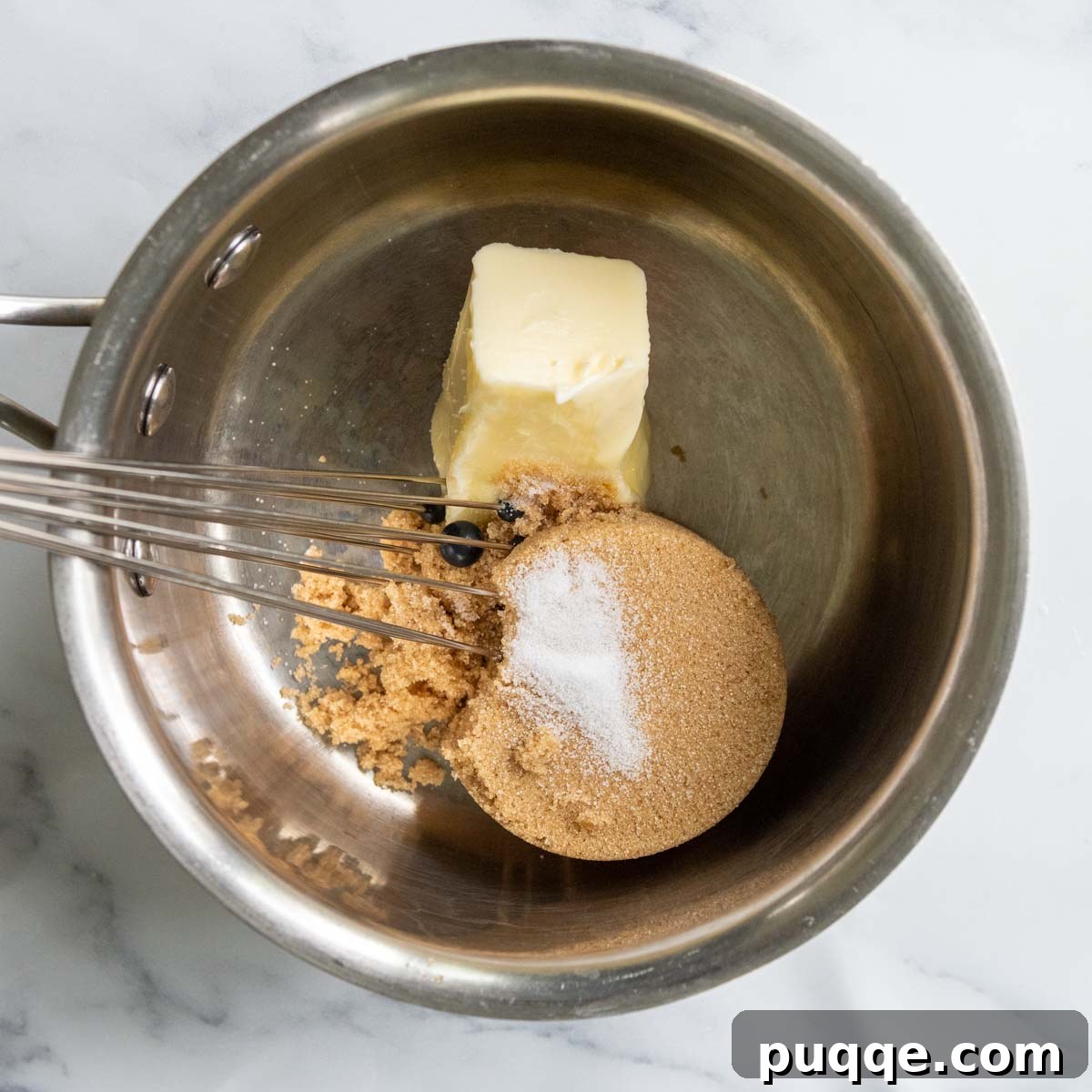 Brown Sugar Praline Glazed Apple Cake 9 Ingredients for brown sugar glaze – butter, brown sugar, milk, and salt – being combined in a saucepan on the stove.