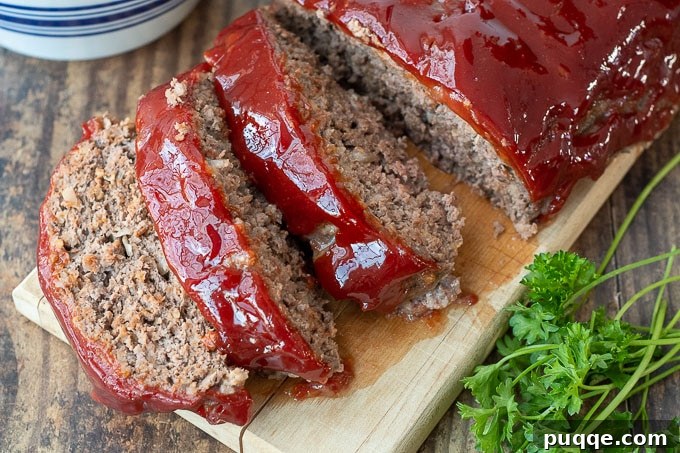 Overhead shot of a delicious Instant Pot meatloaf on a wooden cutting board, ready to be sliced.