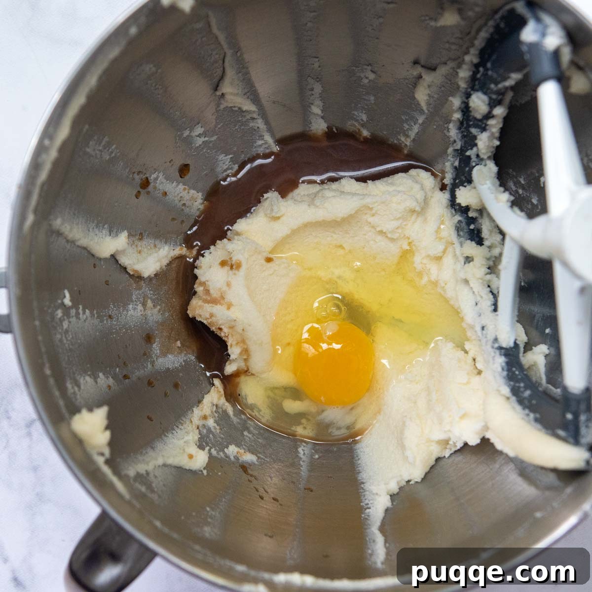Flawless Gluten-Free Cut-Out Sugar Cookies 4 Butter, sugar, egg, milk, and vanilla extract blended into a smooth mixture in a bowl.