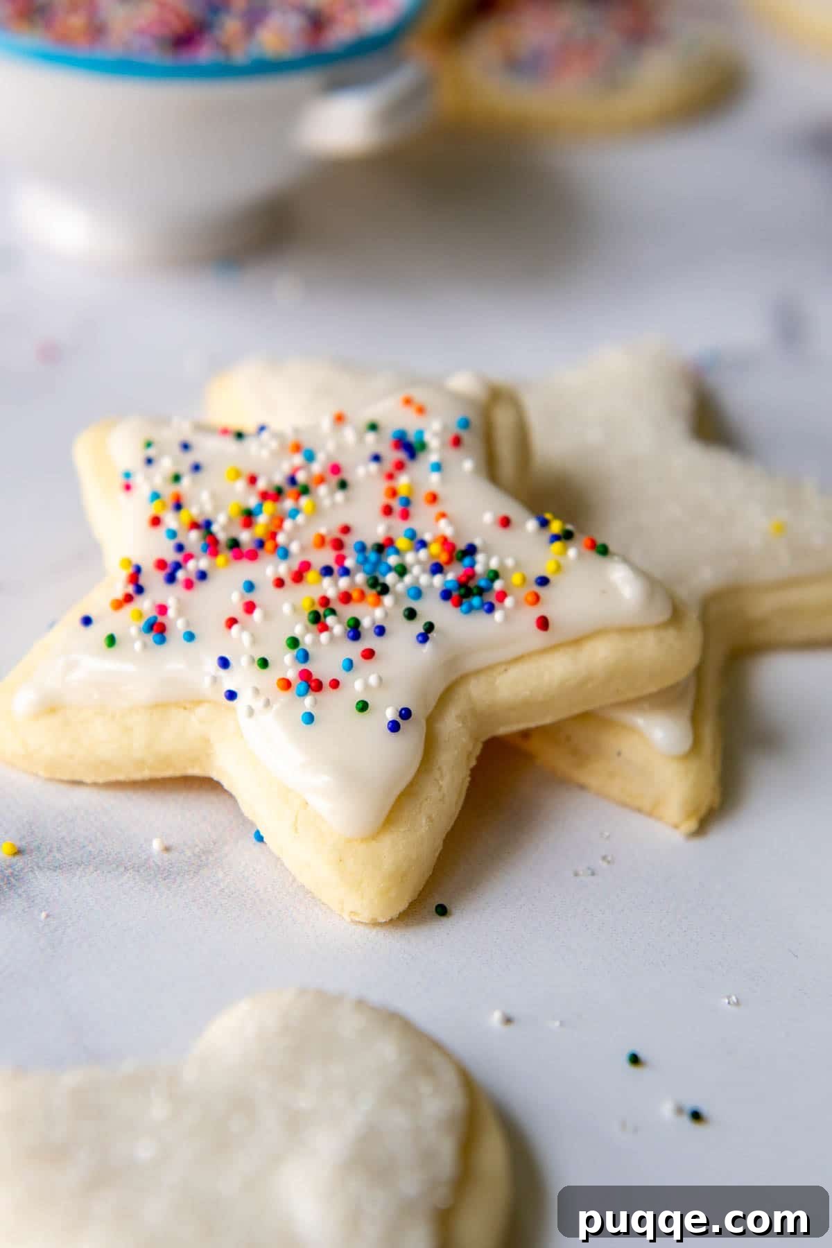 Flawless Gluten-Free Cut-Out Sugar Cookies 7 Close-up of baked gluten-free cookies surrounded by festive sprinkles, ready for decoration.