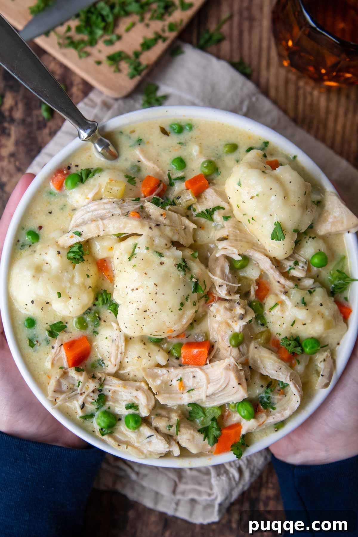 Speedy Gluten-Free Instant Pot Chicken and Dumplings 3 Overhead shot of a white bowl filled with creamy Instant Pot chicken and dumplings, garnished with fresh parsley.