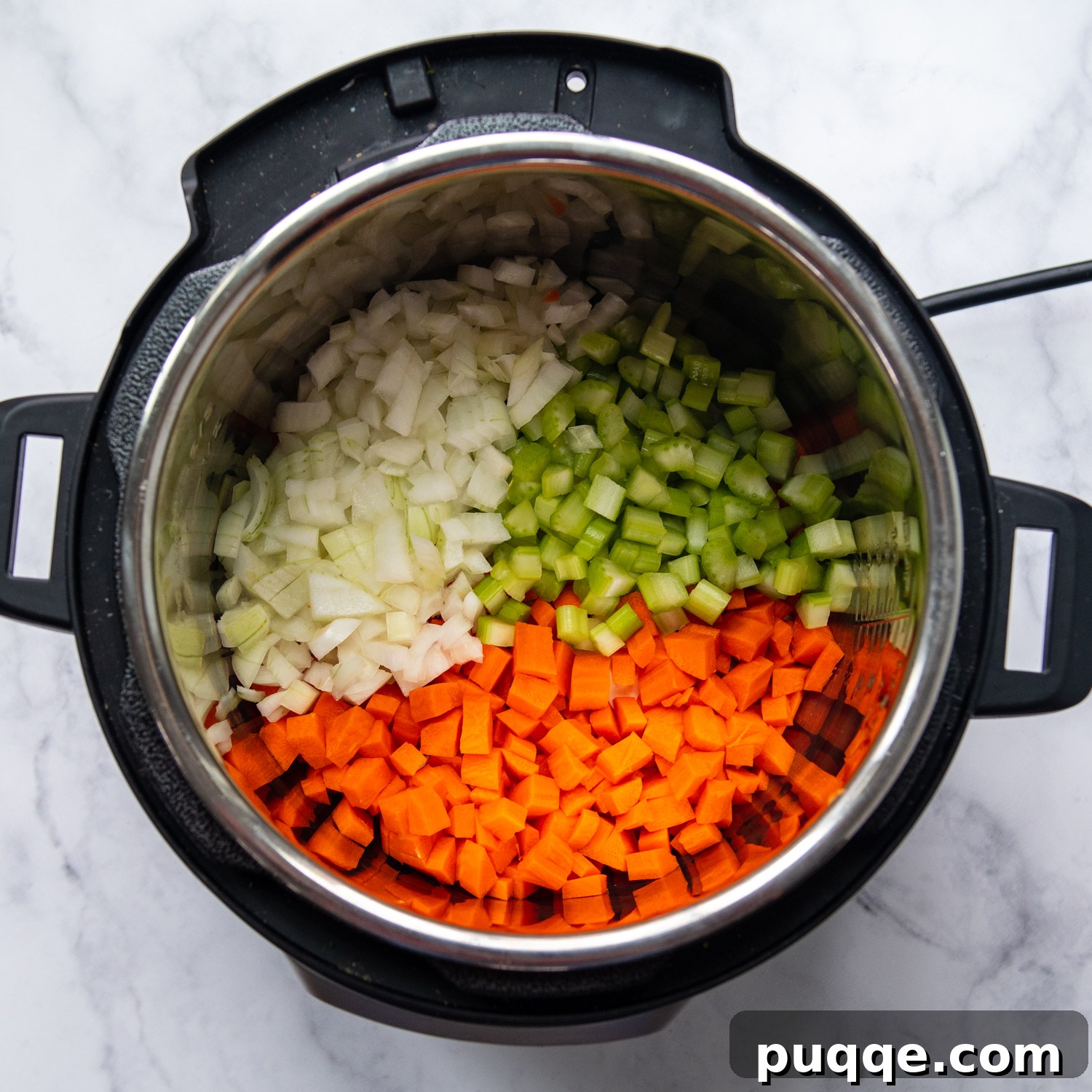 Speedy Gluten-Free Instant Pot Chicken and Dumplings 4 A mix of chopped onions, carrots, and celery being sautéed in butter in an Instant Pot.