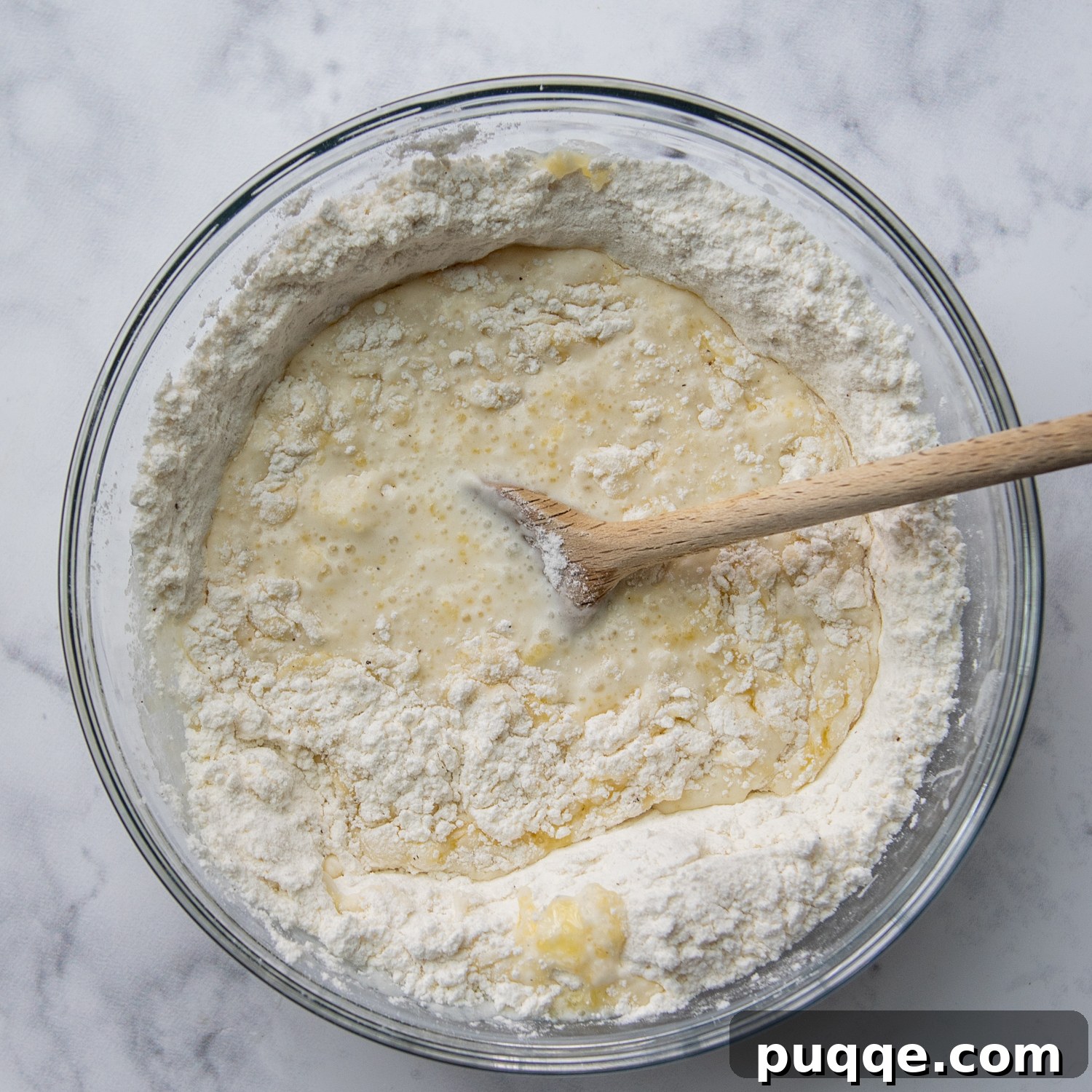Speedy Gluten-Free Instant Pot Chicken and Dumplings 7 Ingredients for gluten-free dumplings being mixed together in a bowl: flour, baking powder, salt, pepper, melted butter, and milk.