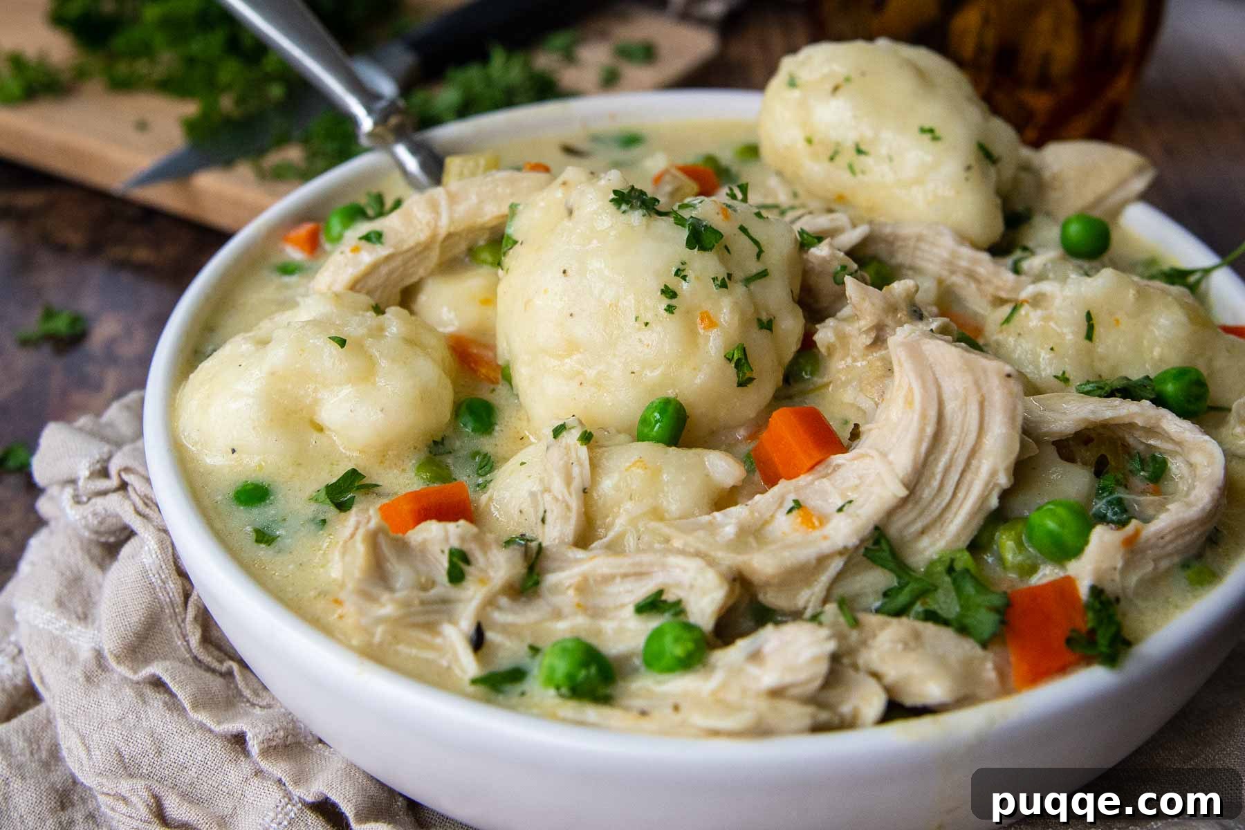 Speedy Gluten-Free Instant Pot Chicken and Dumplings 9 Close-up side angle of a bowl of creamy Instant Pot chicken and dumplings, showing the rich texture and plump dumplings.