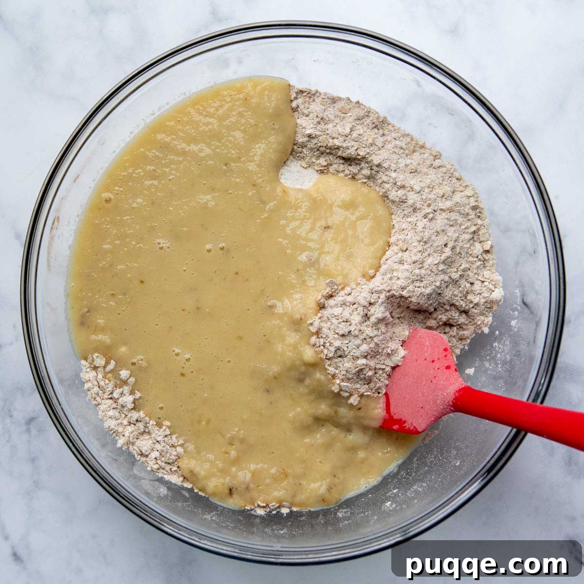 Wholesome Applesauce Oat Muffins 5 Muffin batter being gently stirred, combining wet and dry ingredients.