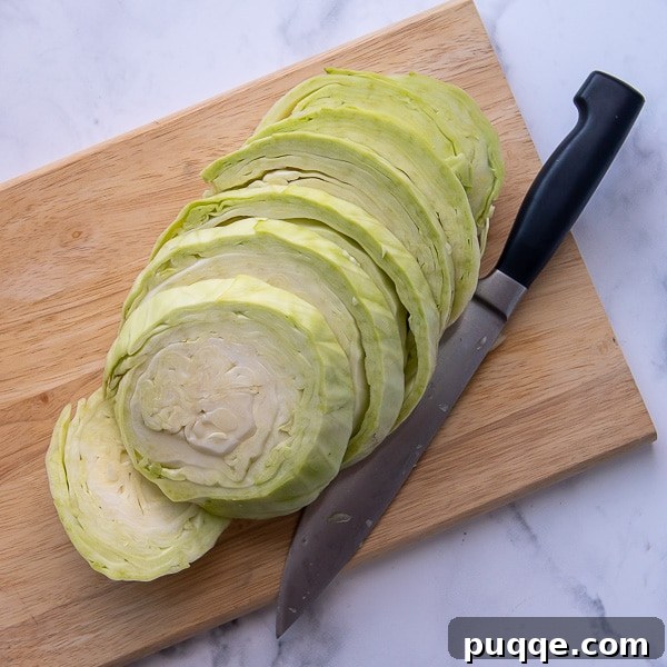 Golden Crispy Cabbage Steaks 3 Image demonstrating how to cut a head of cabbage into perfect half-inch thick slices, also known as cabbage steaks.