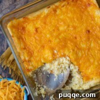 overhead shot of cheese grits casserole with shredded cheese next to it