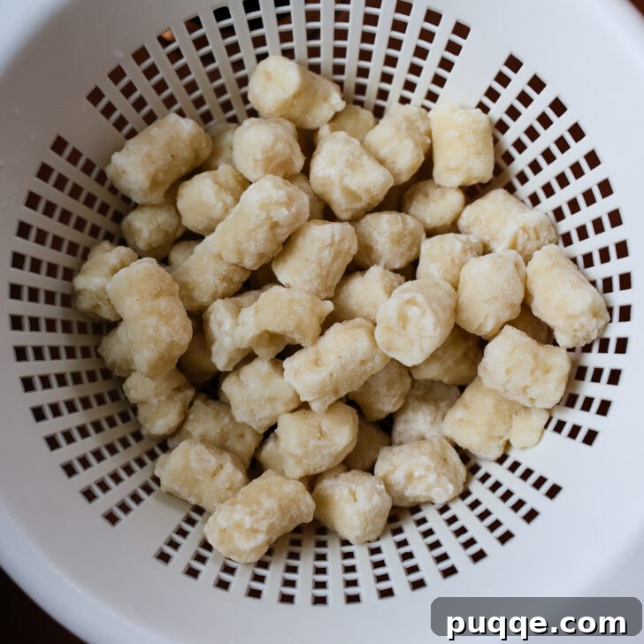 Roasted Gnocchi Sausage & Broccoli Sheet Pan Supper 4 Colander of gnocchi.