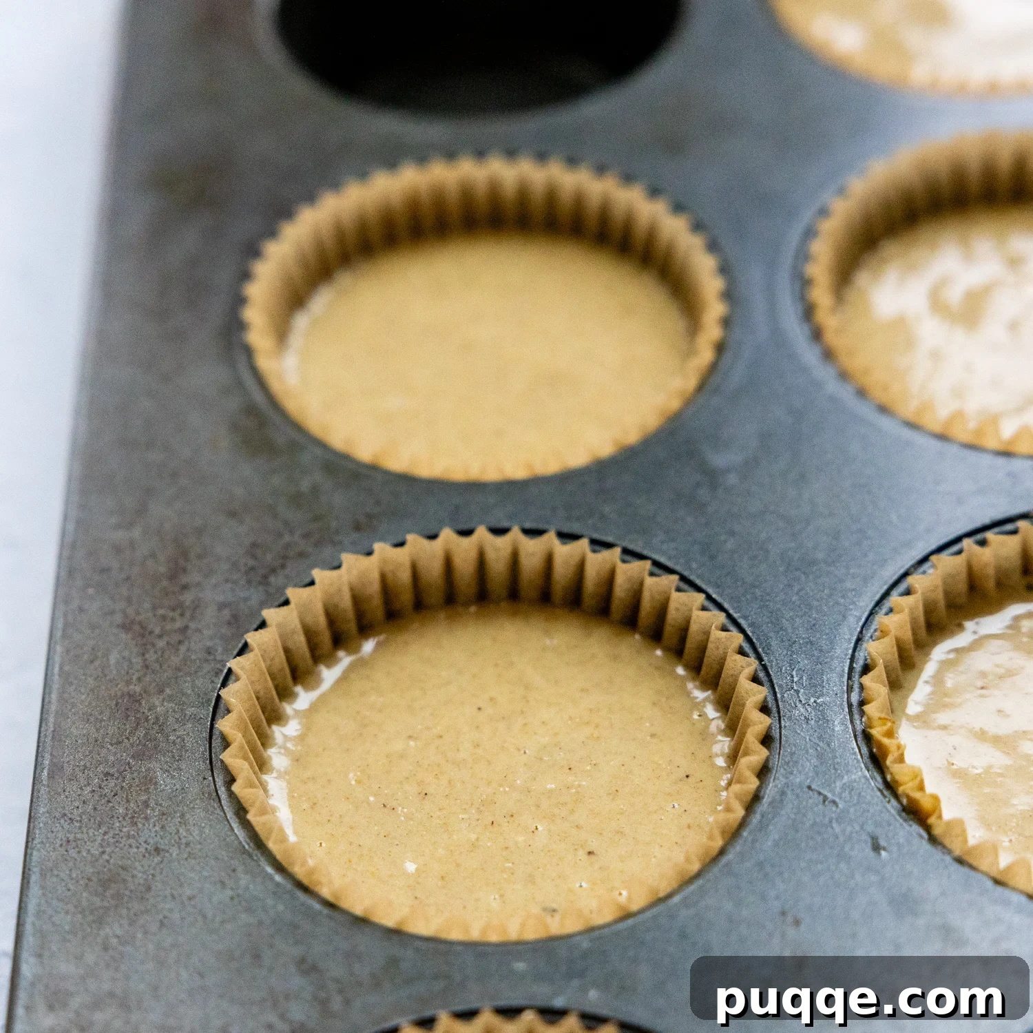 Pillowy Soft Gluten Free Oat Flour Banana Muffins 5 Muffin batter poured into muffin cups, ready to be baked.
