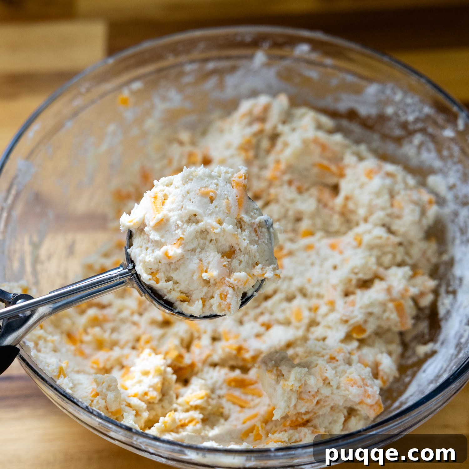 Restaurant Style Buttery Gluten-Free Cheddar Bay Biscuits 5 A mixing bowl filled with the prepared wet and dry biscuit dough mixture, ready for scooping.