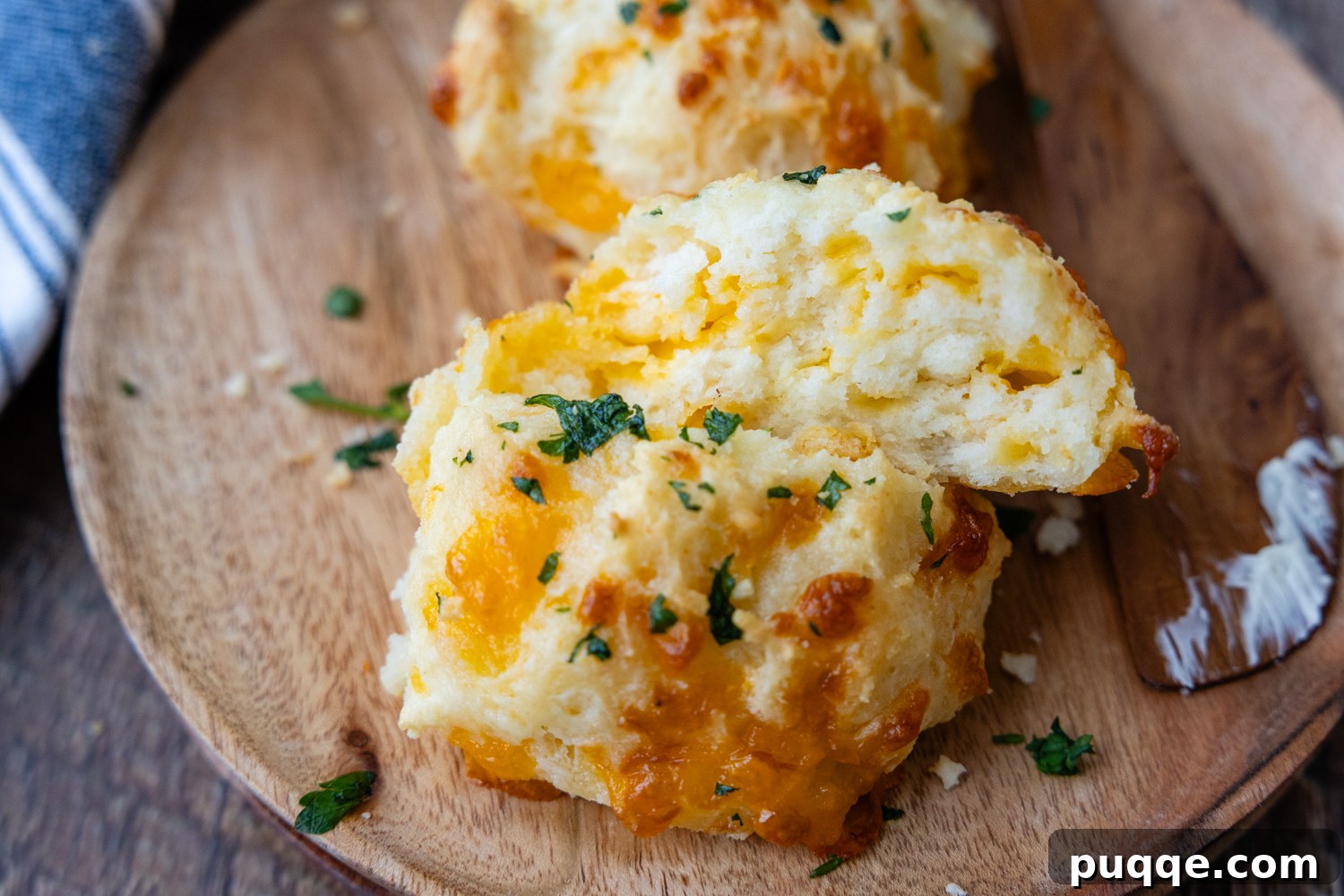 Restaurant Style Buttery Gluten-Free Cheddar Bay Biscuits 8 A single gluten-free cheese biscuit, golden brown and perfectly textured, served on a plate.