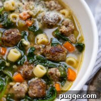 Gluten Free Italian Wedding Soup in a white bowl, ready to be served.