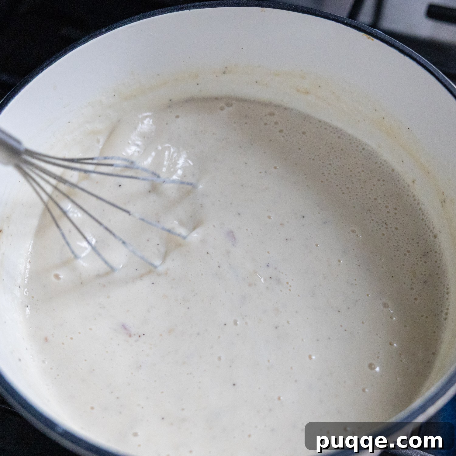Cozy Gluten-Free Chicken and Biscuits 6 Chicken broth being whisked into the flour and butter mixture for the chicken pot pie filling.