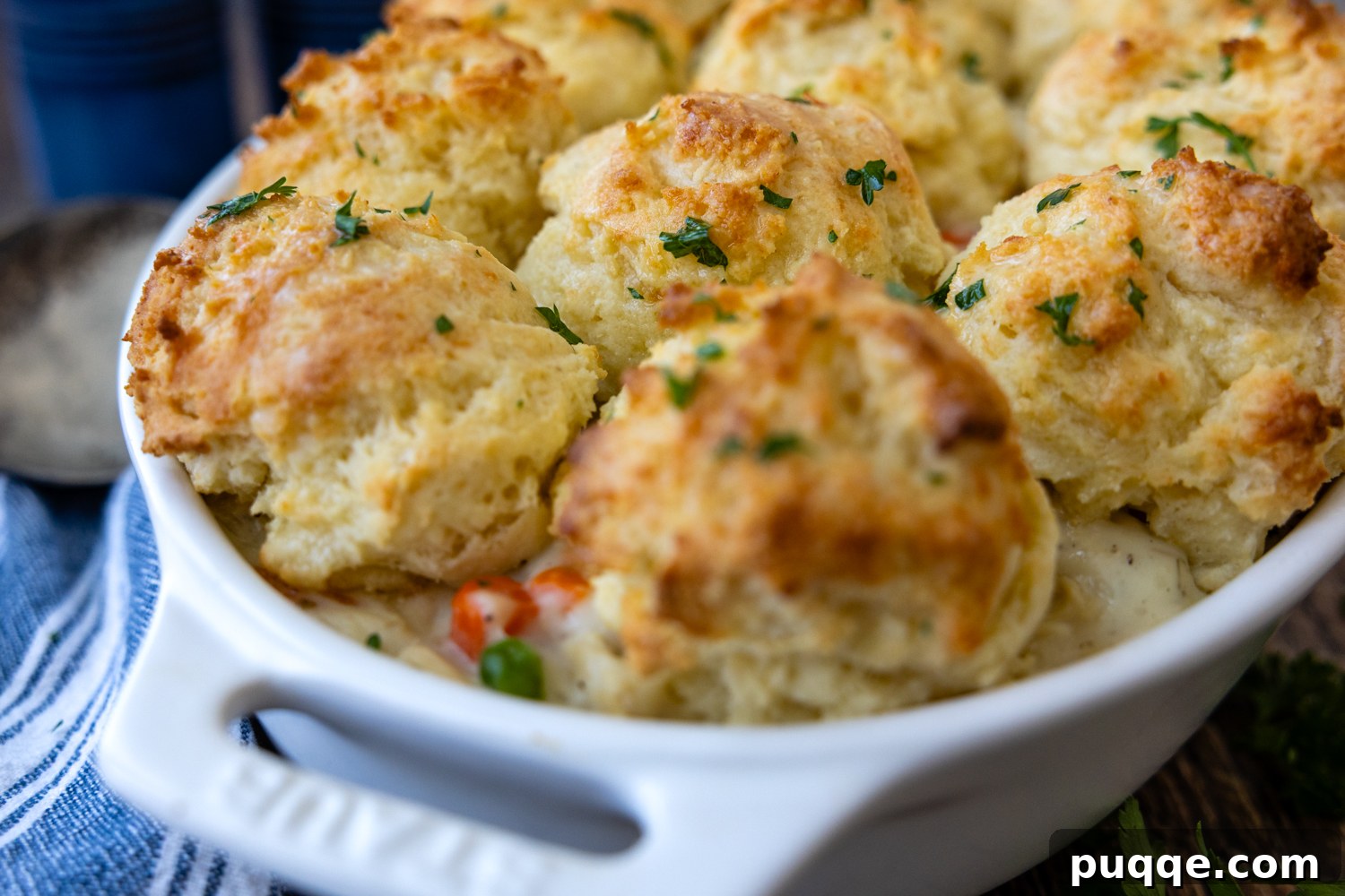 Cozy Gluten-Free Chicken and Biscuits 8 Gluten-Free Chicken and Biscuits baked in a white casserole dish.