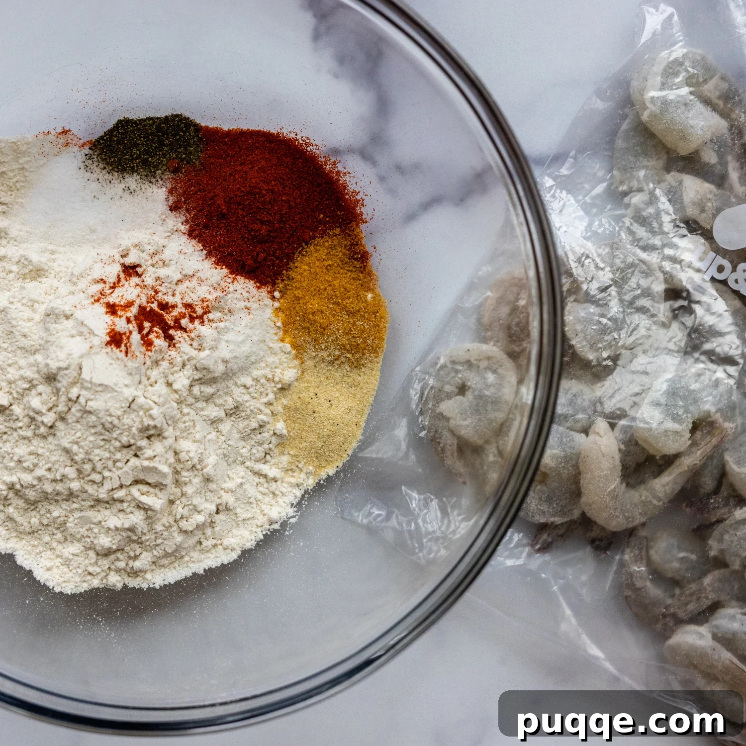 Golden Crispy Gluten-Free Shrimp 4 Dry batter ingredients, including gluten-free flour and spices, mixed in a glass bowl.