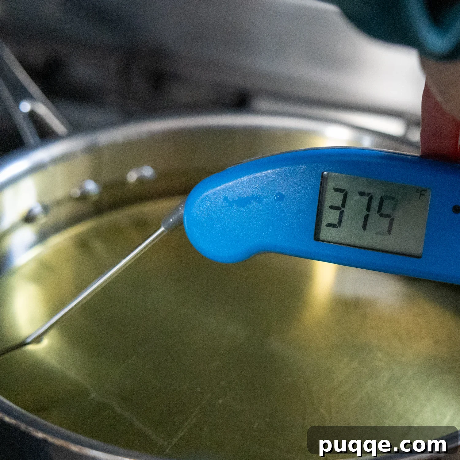 Golden Crispy Gluten-Free Shrimp 5 An instant-read thermometer accurately testing the temperature of hot frying oil in a deep skillet.