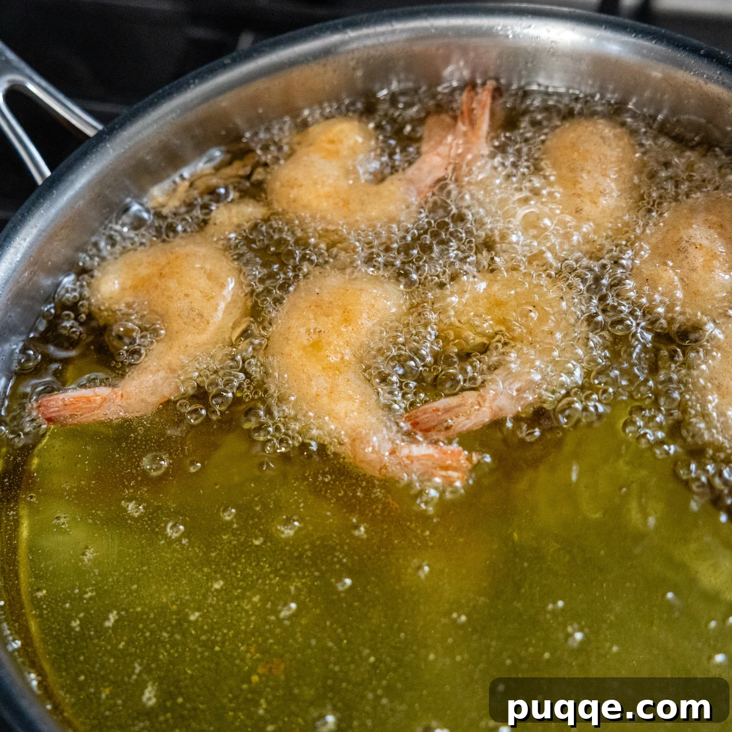 Golden Crispy Gluten-Free Shrimp 7 Gluten-free battered shrimp sizzling and cooking in hot oil in a deep skillet.