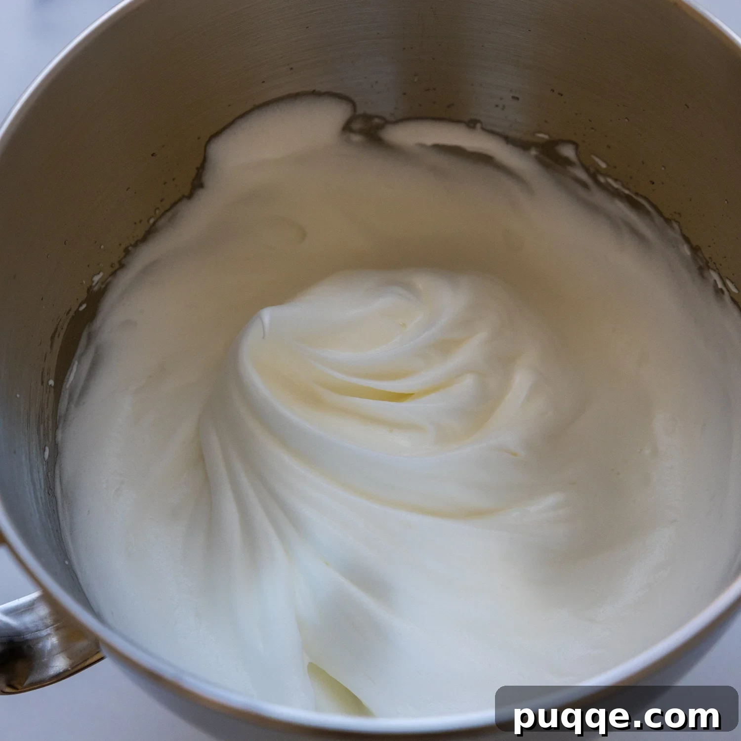 Absolutely Perfect Gluten-Free Tres Leches Cake 3 Foamy egg whites in a mixing bowl, ready for the next step of baking.