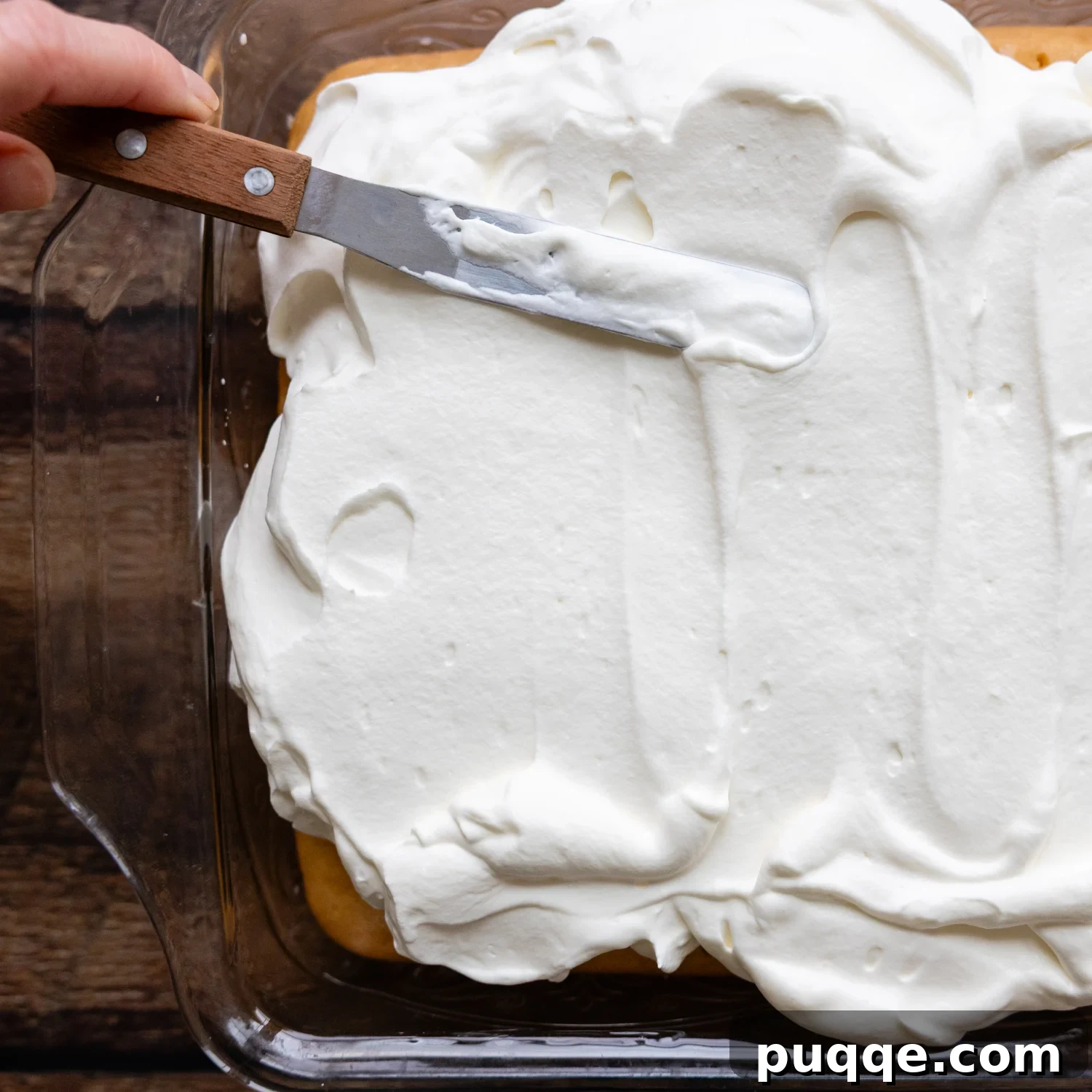 Absolutely Perfect Gluten-Free Tres Leches Cake 8 A freshly frosted gluten-free Tres Leches cake in a glass baking pan.