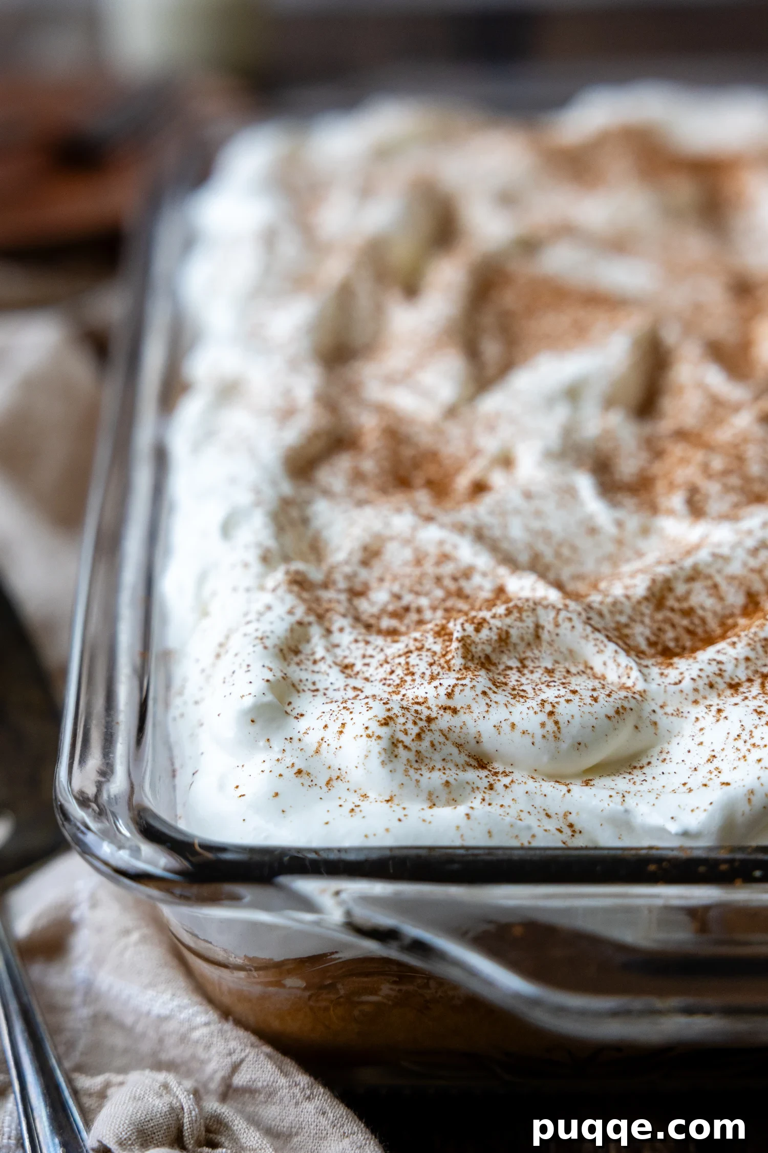 Absolutely Perfect Gluten-Free Tres Leches Cake 9 A beautifully frosted gluten-free Tres Leches cake in a glass cake pan, ready to be served.