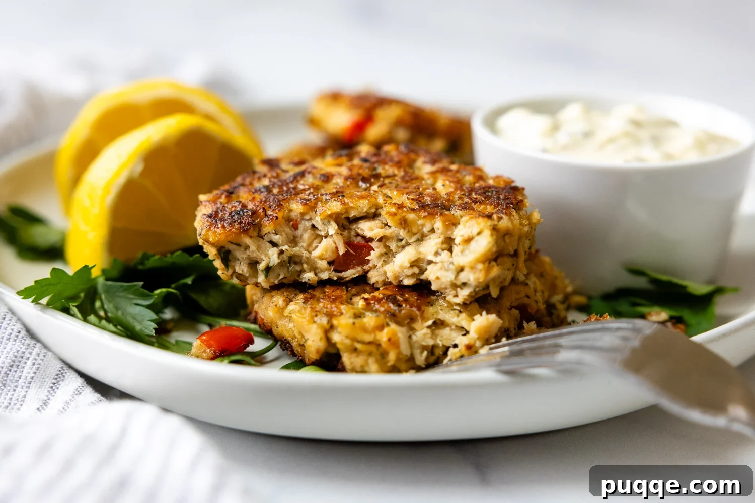 Golden Brown Flourless Salmon Patties 7 Two salmon patties stack and cut open showing the inner texture of the patty.