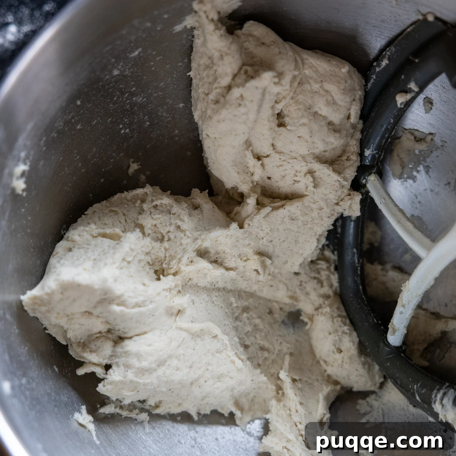 Gluten-free sourdough dough in a stand mixer bowl after mixing, showing its thick, uniform consistency.