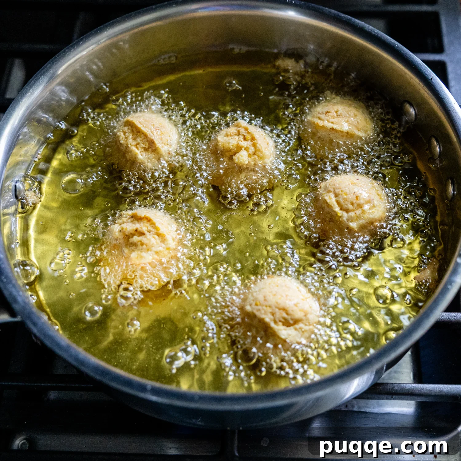Hush puppies added to the oil for frying.