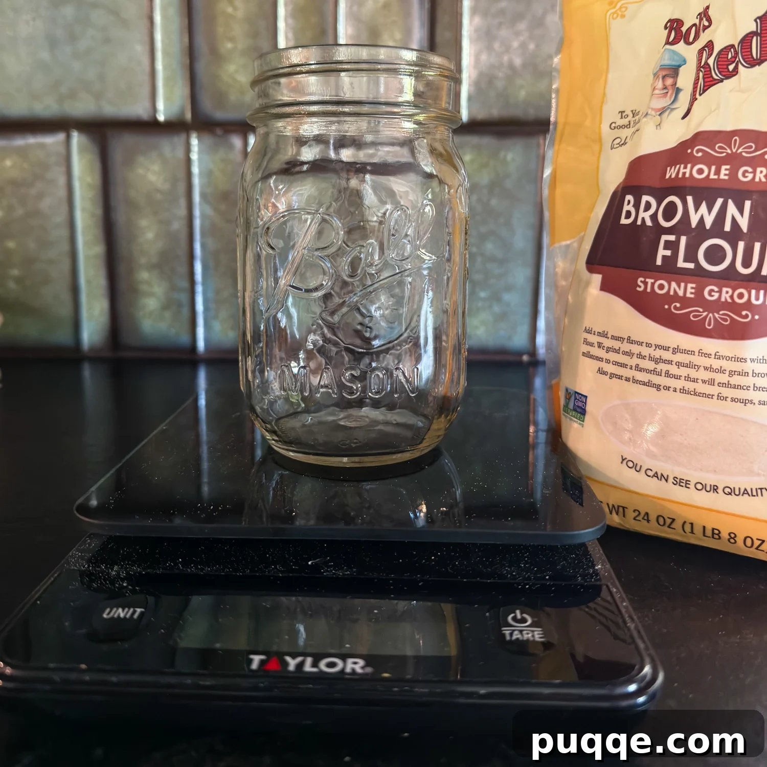 Gluten-Free Sourdough Starter: Reliable Step-by-Step Recipe 4 an empty glass jar on a scale with brown rice flour in the background.