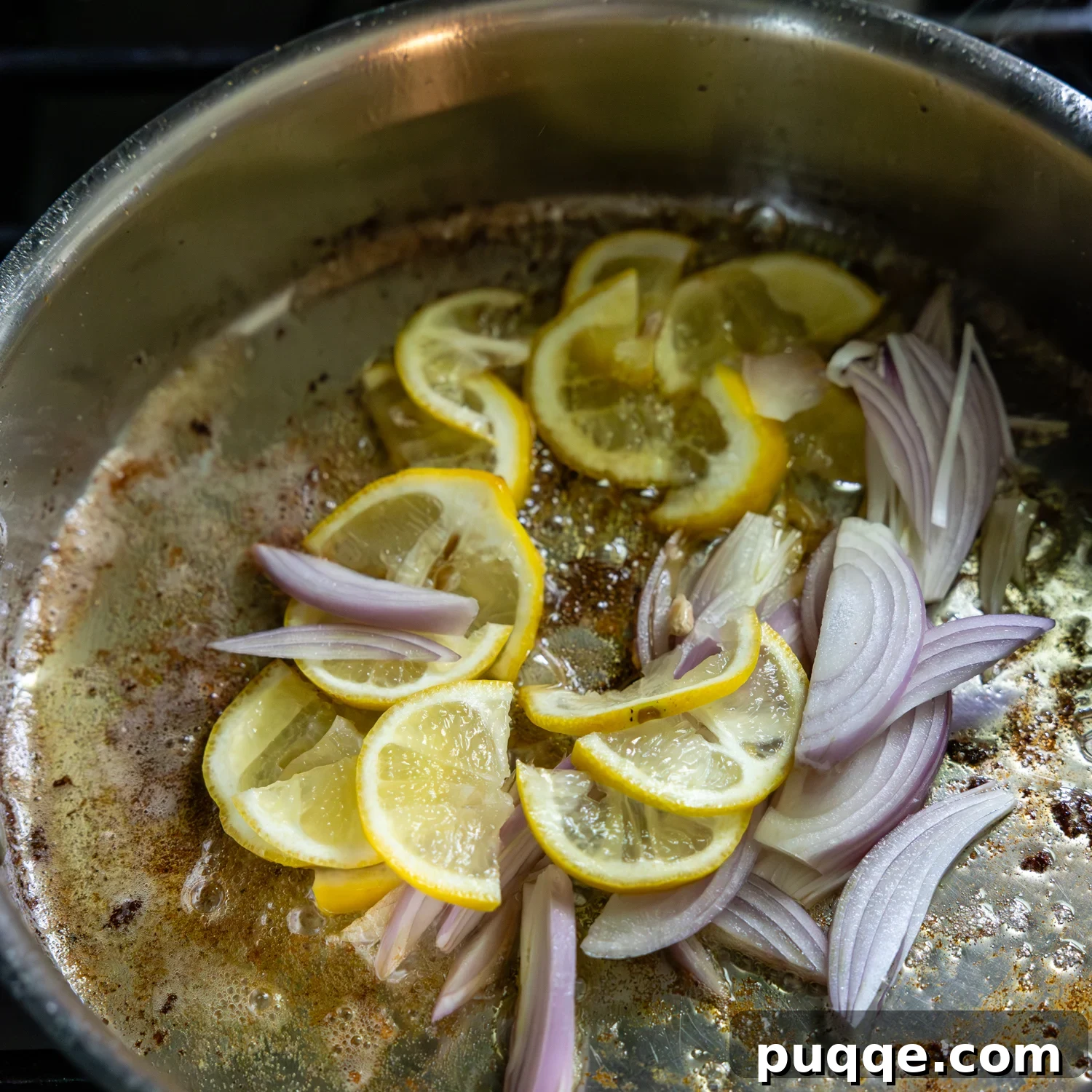 Lemon slices and shallots being sautéed.