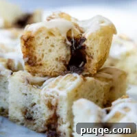 stack of two slices of cinnamon roll focaccia on a marble surface.