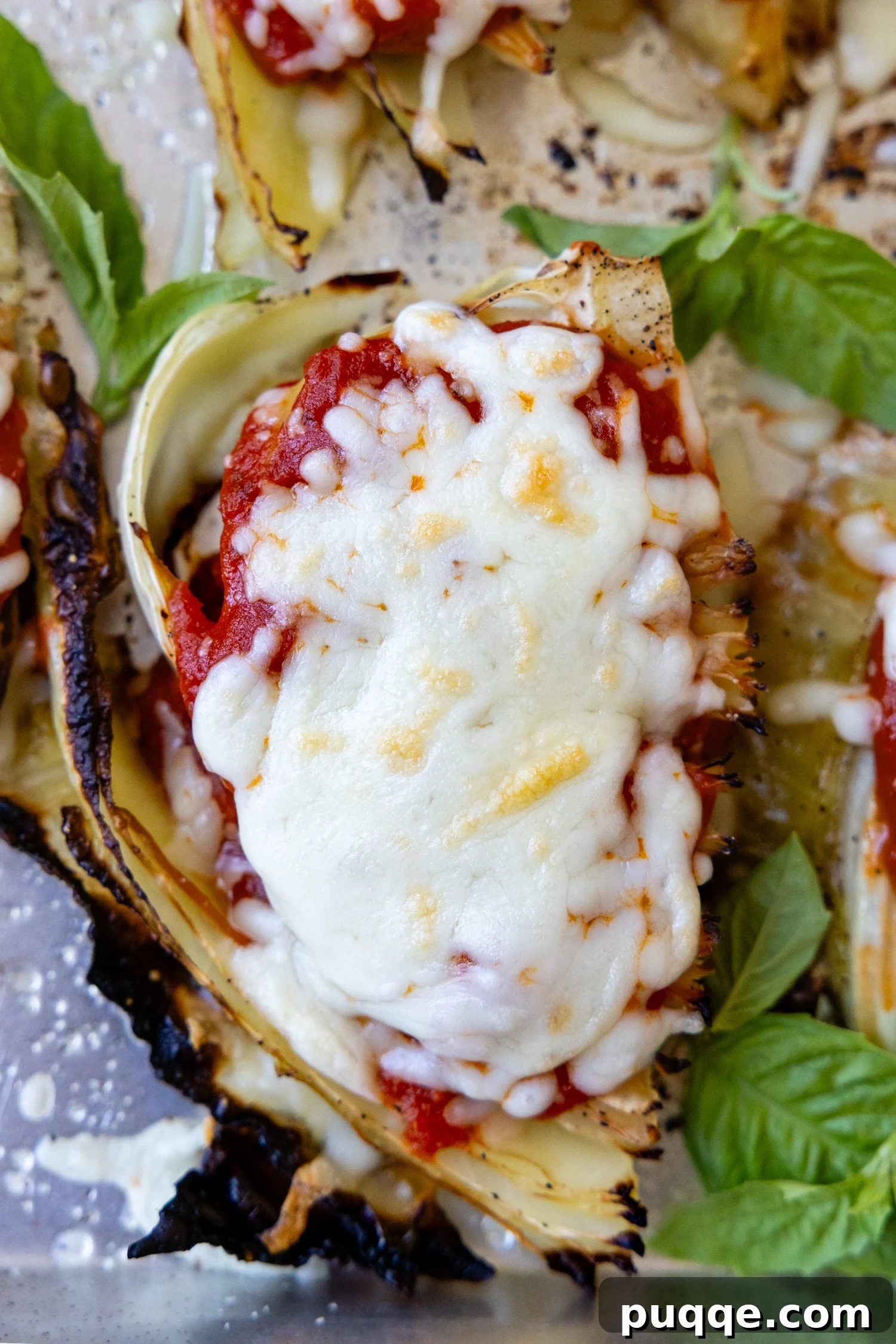 Sheet-Pan Parmesan Roasted Cabbage Wedges 2 top view of cabbage parmesan with bubbly browned cheese on top.