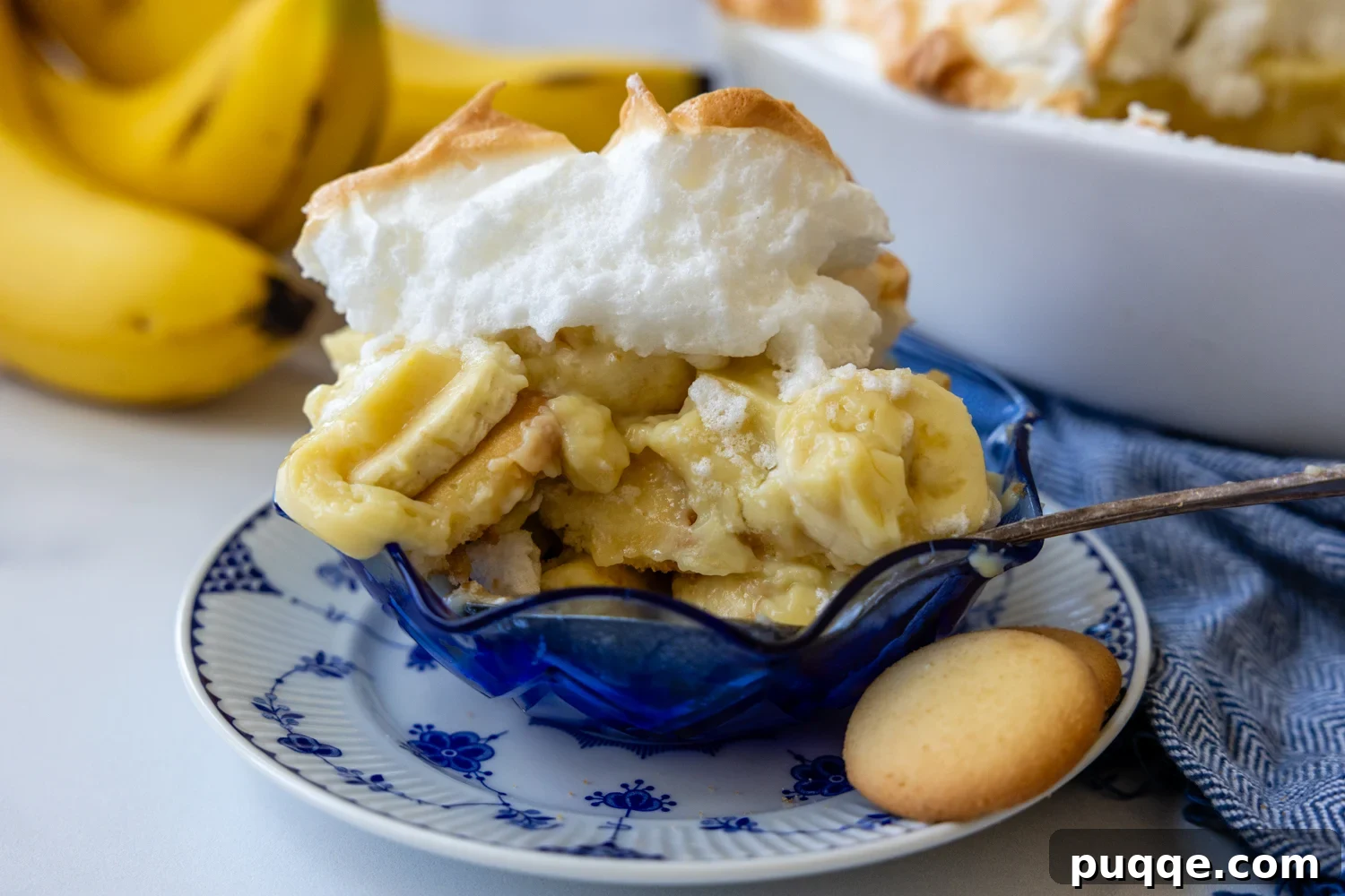 Southern-Style Gluten-Free Banana Pudding (Dolly Parton-Inspired) 11 Banana pudding with wafers in a blue bowl.