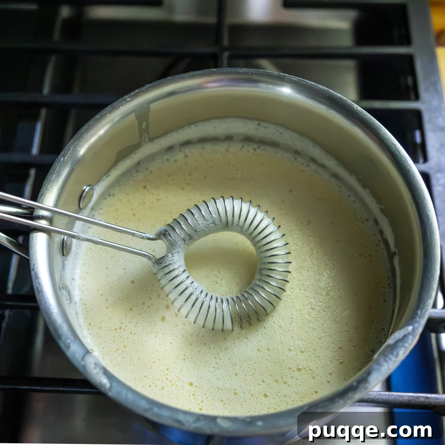 Southern-Style Gluten-Free Banana Pudding (Dolly Parton-Inspired) 5 Mixture in sauce pan with whisk.