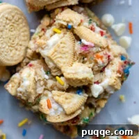 Gluten-Free Funfetti Bars Recipe with Golden Oreos 3 overhead shot of funfetti bars with crushed Oreos on top and a couple Golden Oreos laying next to it.